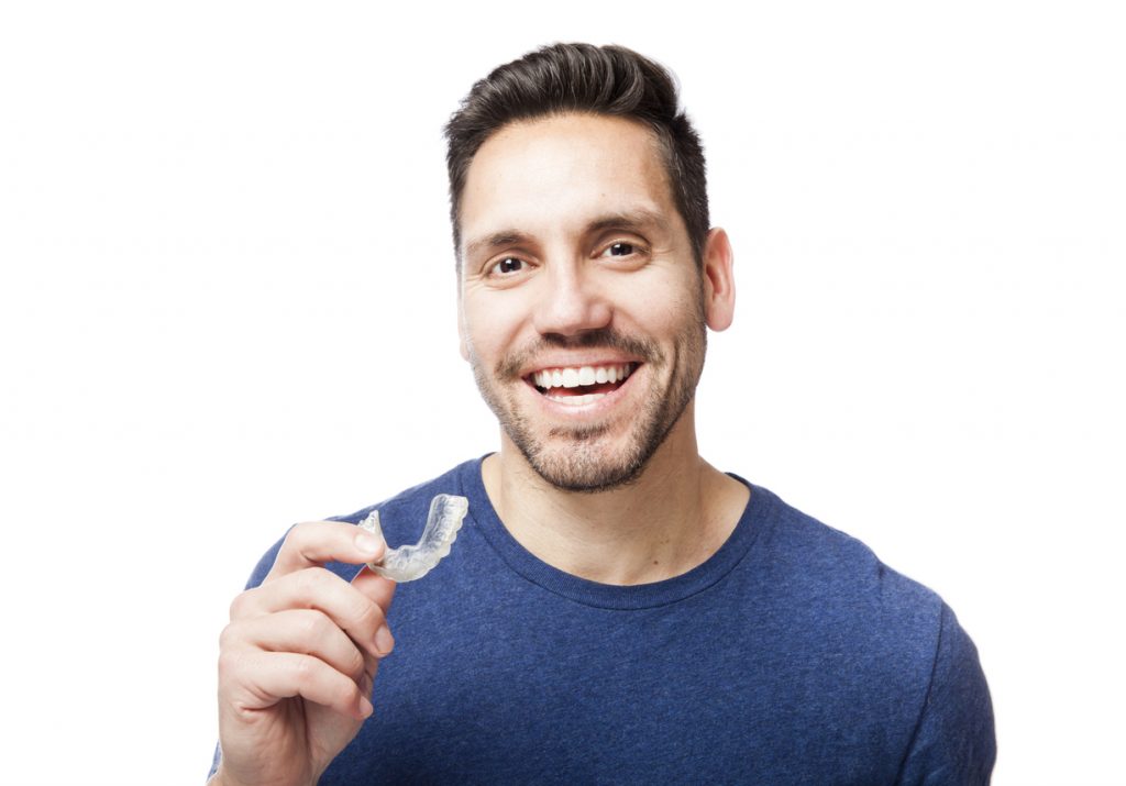 Man holding a mouth guard for snoring